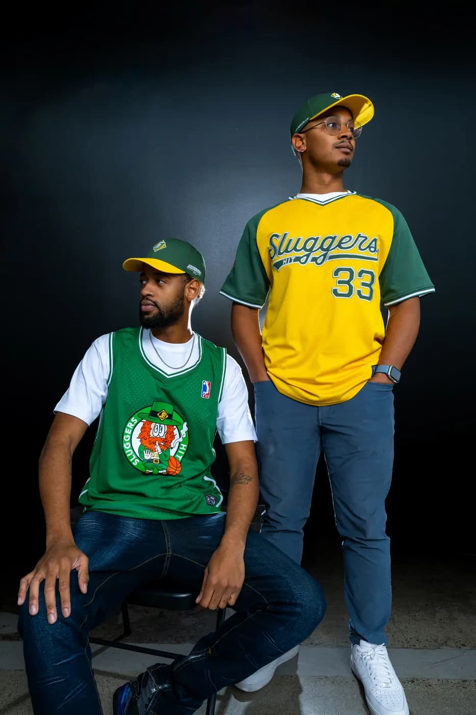 Two men in the away jersey and practice jersey, green and gold